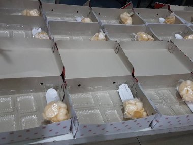 Stack of pizza boxes. Cardboard brown boxes for shipping and delivery of pizza. Many packaging is on the kitchen stock. Food order and delivering concept. Front view.