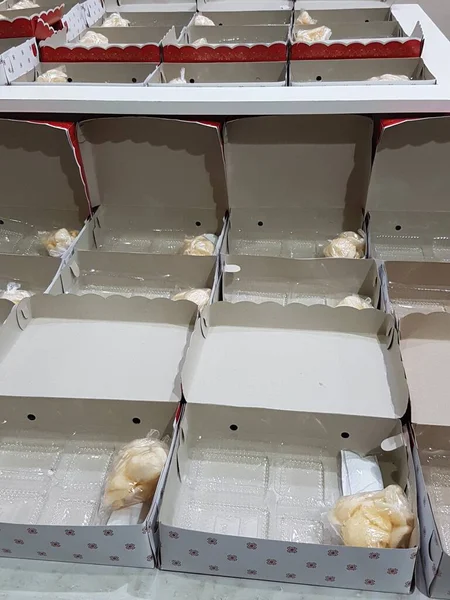 Stack of pizza boxes. Cardboard brown boxes for shipping and delivery of pizza. Many packaging is on the kitchen stock. Food order and delivering concept. Front view.