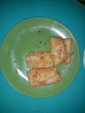 Selective focus risoles sosis mayo (American risoles) or mayonnaise sausage rissole is a small patty rolled in breadcrumbs. it is filled with mayonnaise, boiled egg and sausage. Served on green plate.