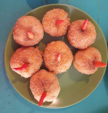 Selective focus risoles sosis mayo (American risoles) or mayonnaise sausage rissole is a small patty rolled in breadcrumbs. it is filled with mayonnaise, boiled egg and sausage. Served on green plate.