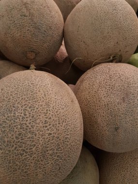 melon fruit in the market. Ripe melons, background for the sale of fruits. pile of melons for sale in the supermarket
