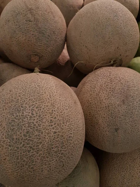 melon fruit in the market. Ripe melons, background for the sale of fruits. pile of melons for sale in the supermarket