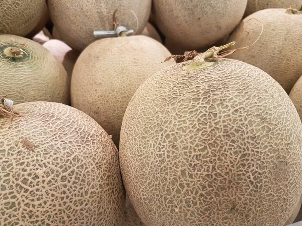 melon fruit in the market. Ripe melons, background for the sale of fruits. pile of melons for sale in the supermarket