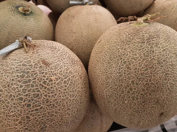 melon fruit in the market. Ripe melons, background for the sale of fruits. pile of melons for sale in the supermarket