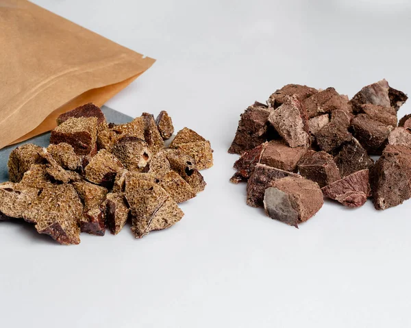 Natural dried treats for dogs. Treats for rewarding and training dogs. Dried meat products for dogs. Animal care.Selective focus. Advertisement for dog treats. Assorted snacks and treats for dogs.