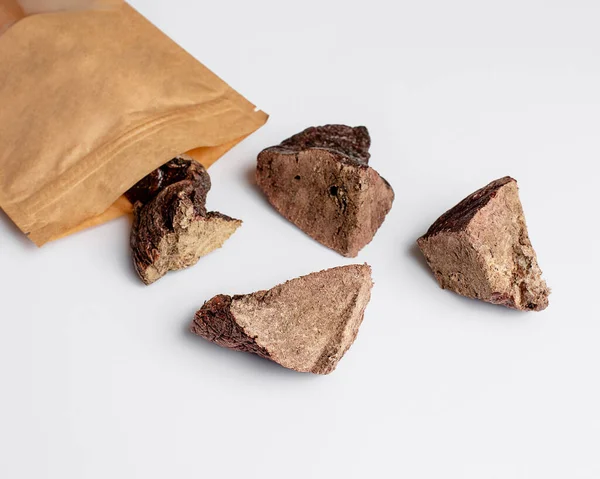 Natural dried treats for dogs. Treats for rewarding and training dogs. Dried meat products for dogs. Animal care.Selective focus. Advertisement for dog treats. beef lung.