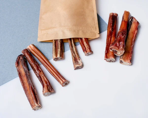 Natural dried treats for dogs. Treats for rewarding and training dogs. Dried meat products for dogs. Animal care.Selective focus. Advertisement for dog treats. bull penis.