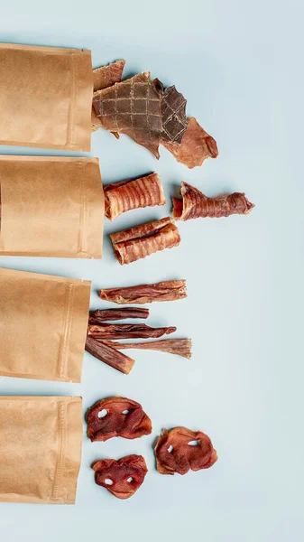 Natural dried treats for dogs. Treats for rewarding and training dogs. Dried meat products for dogs. Animal care.Selective focus. Advertisement for dog treats. Assorted snacks and treats for dogs.