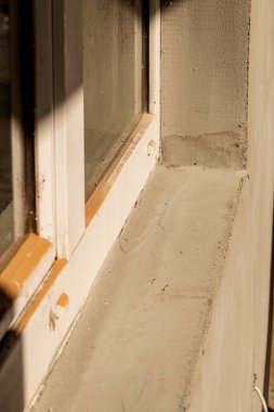 Modern repair and reconstruction of the house. Insulation of the house with polystyrene foam, plastering, applying plaster and painting facade walls using scaffolding when repairing the house. Construction or renovation.