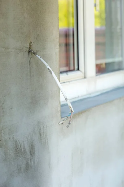 Modern repair and reconstruction of the house. Insulation of the house with polystyrene foam, plastering, applying plaster and painting facade walls using scaffolding when repairing the house. Construction or renovation.