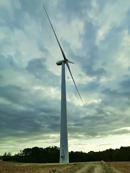 Low-angle and backlight view of a wind turbine, in Yonne.