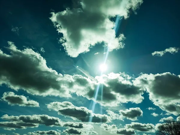 View of a sunny winter sky with cumulus clouds.