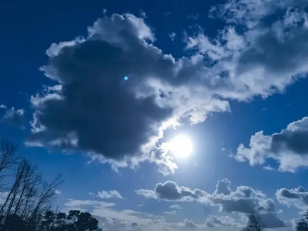 View of a sunny winter sky with cumulus clouds.