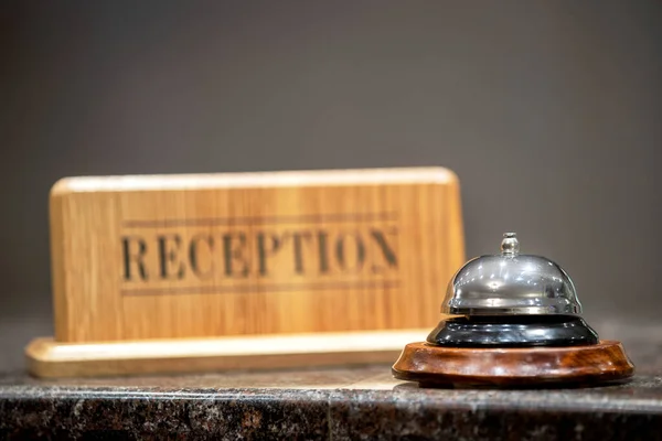 old hotel bell on a marble stand