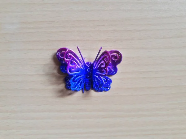 Butterfly Toy Closed Blue Violet Color Isolated Wooden Background — Photo