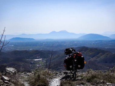 Loaded touring bicycle with mountains in the background. Taken in 400 meter elevation