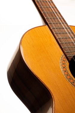 Classical guitar isolated on a white background, emphasizing shape and form, with space for copy