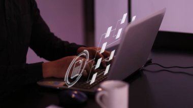 User working on laptop with virtual screen of Document Management System (DMS), a virtual online documentation database. Concept for business and office management. Selective focus.