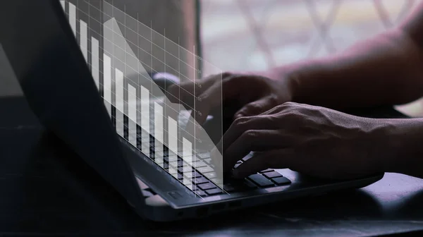 User typing on a laptop with virtual screen of performance graph dashboard. Concept for financial, business, progress performance and dashboard.