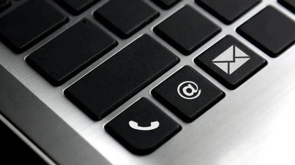 Phone, email and mail icon on laptop keyboard button. Concept for contact us.