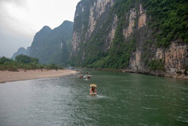 Guilin, Çin - 4 Mayıs 2010: Yerel halk bambu motorlu bir tekneyle Li Nehri boyunca seyahat ediyor