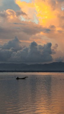 Fisherman Silhouette on His Boat