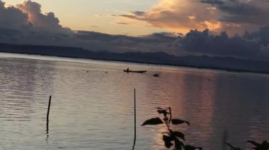 Fisherman Silhouette on His Boat