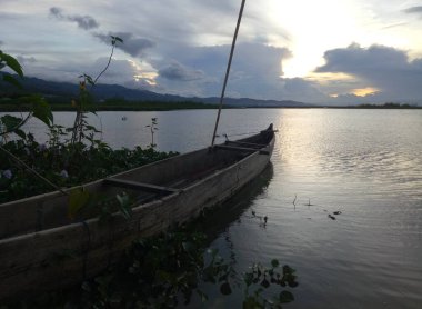 Traditional fishing boat anchored by the lake