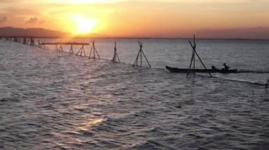 Fisherman Silhouette on His Boat