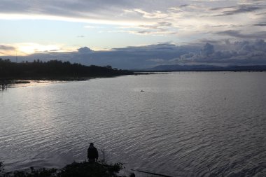 Silhouette of a man fishing in the afternoon. 