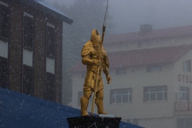 Golden statue guarding the town in cold weather