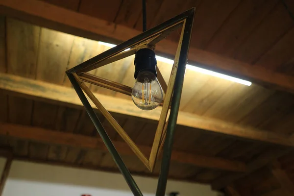 Wodden triangle pendant lamp in coffee shop