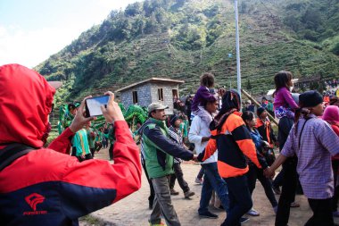 Dieng / Indonesia - August 1, 2015: Dieng Culture Festival, Tourists follow the dreadlocks procession during the Dieng Culture Festival event at Dieng, Banjarnegara district, Central Java
