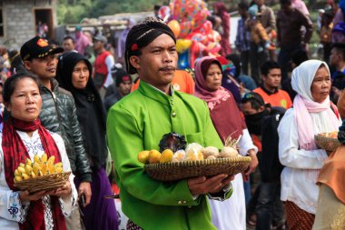 Dieng / Indonesia - August 1, 2015: Dieng Culture Festival, Tourists follow the dreadlocks procession during the Dieng Culture Festival event at Dieng, Banjarnegara district, Central Java