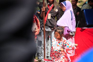 Dieng / Indonesia - August 1, 2015: Dieng Culture Festival, Tourists follow the dreadlocks procession during the Dieng Culture Festival event at Dieng, Banjarnegara district, Central Java