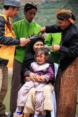 Dieng / Indonesia - August 1, 2015: Dieng Culture Festival, Tourists follow the dreadlocks procession during the Dieng Culture Festival event at Dieng, Banjarnegara district, Central Java