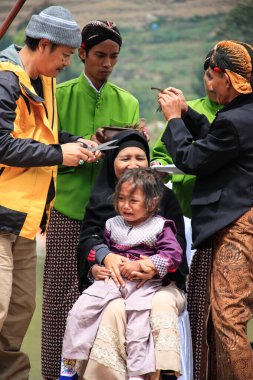 Dieng / Indonesia - August 1, 2015: Dieng Culture Festival, Tourists follow the dreadlocks procession during the Dieng Culture Festival event at Dieng, Banjarnegara district, Central Java