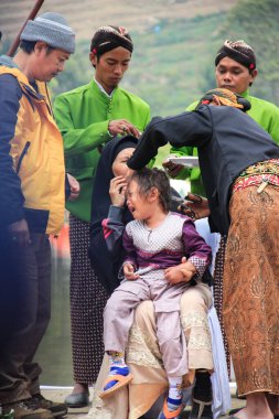 Dieng / Indonesia - August 1, 2015: Dieng Culture Festival, Tourists follow the dreadlocks procession during the Dieng Culture Festival event at Dieng, Banjarnegara district, Central Java