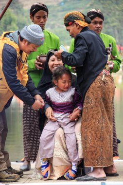 Dieng / Indonesia - August 1, 2015: Dieng Culture Festival, Tourists follow the dreadlocks procession during the Dieng Culture Festival event at Dieng, Banjarnegara district, Central Java