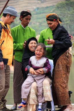 Dieng / Indonesia - August 1, 2015: Dieng Culture Festival, Tourists follow the dreadlocks procession during the Dieng Culture Festival event at Dieng, Banjarnegara district, Central Java