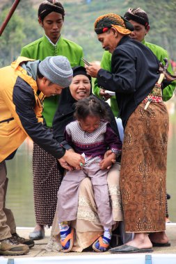 Dieng / Indonesia - August 1, 2015: Dieng Culture Festival, Tourists follow the dreadlocks procession during the Dieng Culture Festival event at Dieng, Banjarnegara district, Central Java