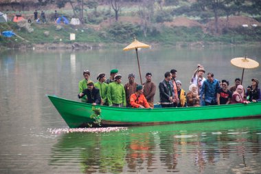 Dieng / Indonesia - August 1, 2015: Dieng Culture Festival, Tourists follow the dreadlocks procession during the Dieng Culture Festival event at Dieng, Banjarnegara district, Central Java