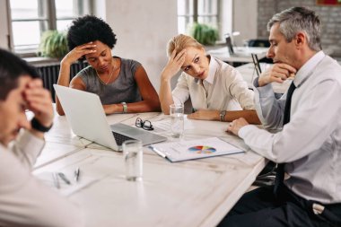 Worried business team having problems during a meeting in the office. 