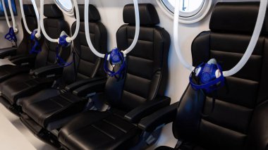 Hyperbaric chamber with masks and empty seats.