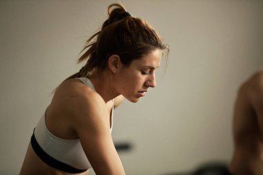 Young athletic woman having sports training in health club.