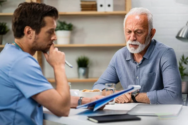 Senior Man Feeling Worried While Analzying His Medical Reports Doctor — Fotografia de Stock