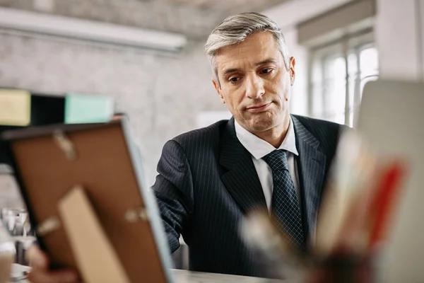 Mid Adult Businessman Feeling Sad While Looking Photo Picture Frame — Stock Fotó