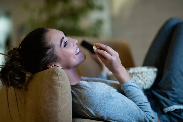 Young Happy Woman Relaxing Armchair Night Watching Movie While Eating — Stockfoto