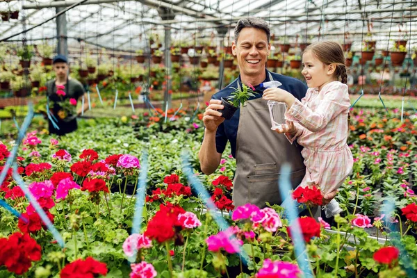 Happy Father Daughter Nourishing Potted Flowers Watering Them Greenhouse — Fotografia de Stock
