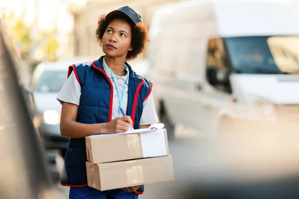Female African American Deliverer Carrying Packages Filling Paperwork City — Stockfoto